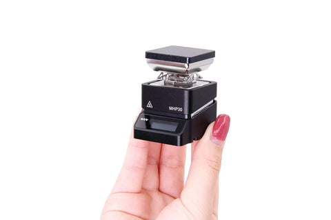 Person holding Ultra Compact Mini Hot Plate Soldering Preheater with OLED Display and 60W Power, small and portable design