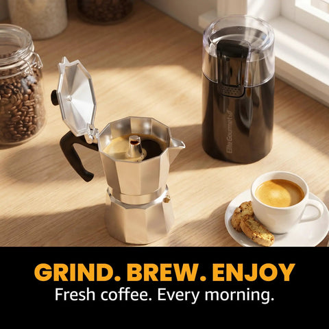 Elite Gourmet ECG914 Electric Coffee And Spice Grinder Heavy Duty Stainless Steel Blade One Touch Operation Black Compact Design with coffee pot and cup.
