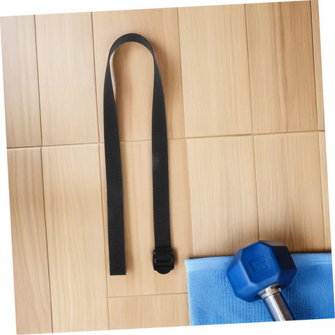 4 Pack Rowing Machine Foot Straps Replacement Nylon Pedal Straps With Non Slip Padding And Adjustable Elastic Fit For All Major Machines Easy Install Premium Comfort For Training Sessions black nylon strap with buckle on wood floor