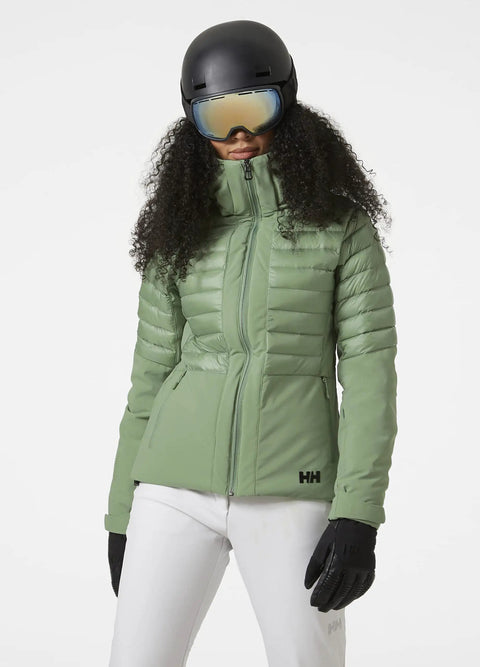 Woman wearing green Womens Slick Waterproof Insulated Ski Jacket With H2Flow Tech, ski gloves, and helmet, front view.