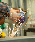 Worker wearing True Wireless Buds With Heat Activated Memory Foam Eartips For 22 dB Noise Reduction using grinder