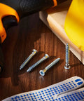 100 Pack 7mm By 50mm Confirmat Screws For Wood Cabinets And DIY Projects shown with drill and safety gear