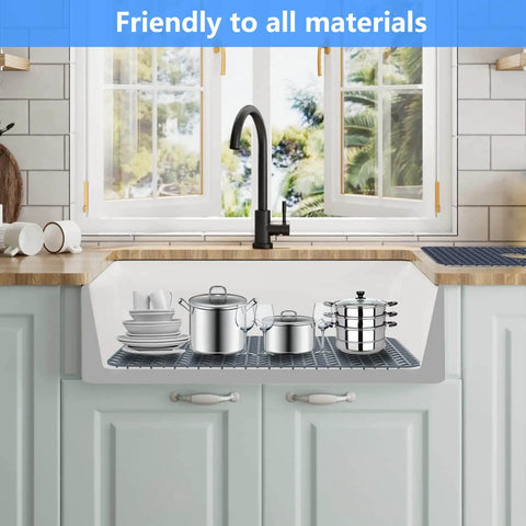 Pro Grade Silicone Sink Mat Grid for kitchen sink protection with dishes and pots displayed in a farmhouse kitchen setting.