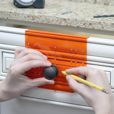 Hands using DIY Friendly No-Fuss All In One Cabinet Door And Drawer Drill Mounting Template For Precise Knob And Pull Installation