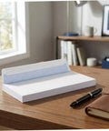 100 Pack White Self Seal Envelopes With Release Paper For Privacy Protection on a desk with a pen and notebook