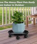 6 Pack Heavy Duty Plant Caddies With Wheels, Smooth Rolling Plant Dollies For Indoor Outdoor Potted Plants, Sturdy Black Plastic Saucers With Glide Casters on a patio with a blue potted plant.