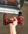 Beefy Compact Cordless Hammer Drill And Driver Kit With Half Inch Chuck And Frameless Motor in hand drilling metal frame.
