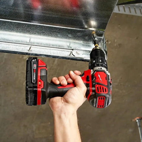 Beefy Compact Cordless Hammer Drill And Driver Kit With Half Inch Chuck And Frameless Motor in hand drilling metal frame.