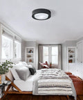 Matte Black Flush Mount Ceiling Light With White Frosted Glass Shade in modern bedroom setting