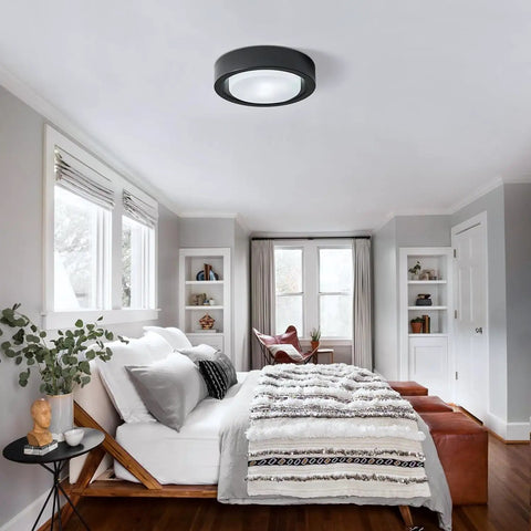 Matte Black Flush Mount Ceiling Light With White Frosted Glass Shade in modern bedroom setting