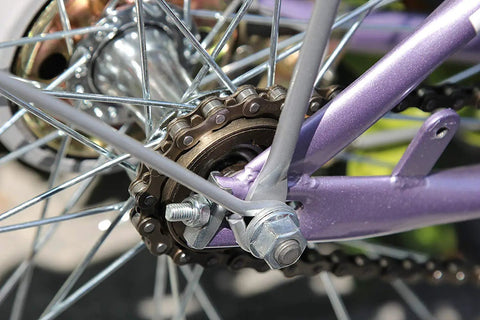 Close-up of a bicycle wheel with a single speed bike chain for fixed gear and mountain bikes one half by one eighth inch 116 links.