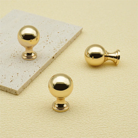 10 Pack Polished Gold Ball Cabinet Knobs Set 1 Inch Diameter Zinc Alloy Dresser Drawer Handles on light surface