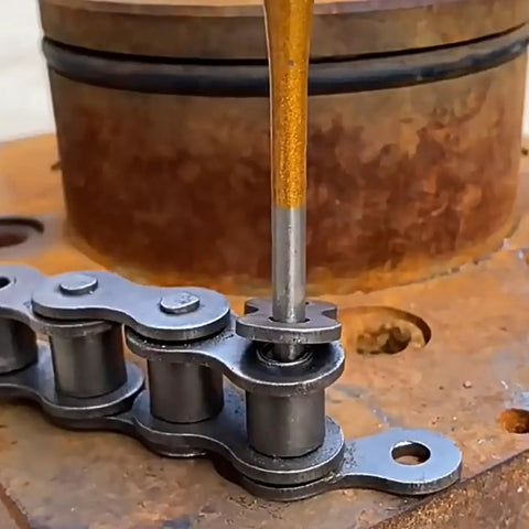 Close-up of 12 Piece Punch And Chisel Set Beefy Heavy Duty Heat Treated Metal Punches being used on a metal chain, 40Cr steel.