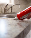 Applying Silicone Acrylic Caulk And Sealant For Kitchen Bathroom And Windows 100 Percent Waterproof Paintable With Duraguard White 5.5 Oz Easy Toolin next to sink