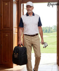 Man holding Custom Embroidered Golf Shoe Bag For Men With Monogram, large capacity zippered carrier with top strap in a golf club.