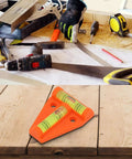 Orange T Shaped 2 Way Bubble Level For Caravan For Motorhome For Camper on wooden surface with tools in background.