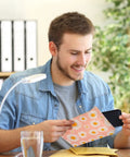 Smiling man holding a pink 6x10 bubble mailer with self seal padded envelopes patterned with fancy daisies usable size 6x9.