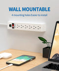 Six Outlet Surge Protector Power Strip With Four Foot Extension Cord, 600 Joules Surge Protection, wall mounted next to laptop