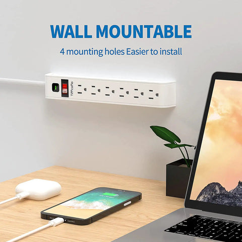 Six Outlet Surge Protector Power Strip With Four Foot Extension Cord, 600 Joules Surge Protection, wall mounted next to laptop