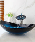 Blue 21 Inch Oval Glass Vessel Sink With Faucet And Pop Up Drain Above Counter Modern Bathroom Vanity Setup Tempered Hand Painted Glass Artistic Yet Slick, shown with water flowing from chrome faucet.