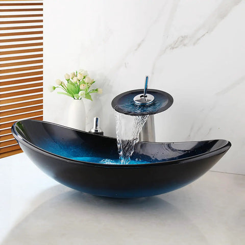 Blue 21 Inch Oval Glass Vessel Sink With Faucet And Pop Up Drain Above Counter Modern Bathroom Vanity Setup Tempered Hand Painted Glass Artistic Yet Slick, shown with water flowing from chrome faucet.