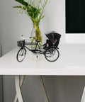 Absolutely Sweet Mini Motorcycle And Vintage Rickshaw Cake Topper With Detailed Metal Alloy Body on a desk with flowers.
