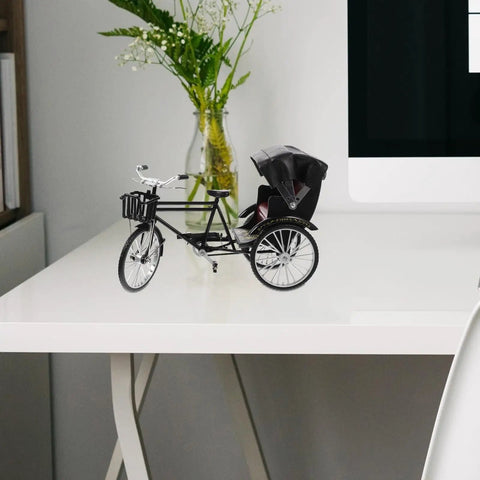 Absolutely Sweet Mini Motorcycle And Vintage Rickshaw Cake Topper With Detailed Metal Alloy Body on a desk with flowers.