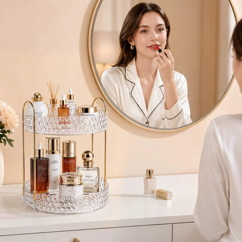 Two Tier Clear Rotating Makeup Organizer Stand Featuring Butter Smooth 360 Spin and Rock Solid Wobble Free Stability for Your Daily Skincare Routine with Reinforced Metal Base, displaying cosmetics and skincare products.