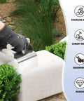 Person using Concrete Curb Trowel Edger With Wave Putty Knife, Ergonomic 4x6x4 Inch Handle for shaping edges, surrounded by plants.