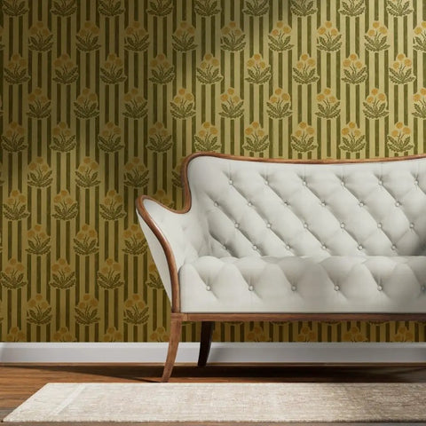 Top Shelf Dandelion Olive And Rich Gold Metallic Wallpaper Featuring A Luxe Fibrous Texture and that Premium Glow Everyone Loves Eco Certified Wallcovering Built Right Here In The USA For Your Next Home Upgrade with green and gold floral pattern behind a white tufted sofa.