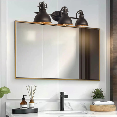 Beacon 27 Inch Three Light Industrial Vanity Light with Brass Interior Shades over bathroom mirror in oil rubbed bronze finish