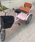 Hassle Free Fold Tandem Tricycle For Adults And Seniors With Rear Bucket Seat And Locking Safety Strap 20 Inch Front Wheel Heavy Duty Steel Frame Bright Pink Chill City Cruisers side view with black basket.