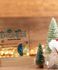 Engineer Definition Acrylic Sign Desk Decor 4 x 4 Inches with holiday decorations, featuring wooden frame and festive background.