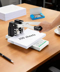 Heavy Duty Two Hole Punch Boasting A Sure Grip And Rugged Steel Body That Blows Through Two Hundred Sheets With No Sweat For Fast Office Jobs School Essays And Snappy Binder Prep In Clean White on wooden table.
