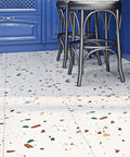 Colorful terrazzo peel and stick floor tiles in kitchen with blue cabinets and black stools, 12x12 inch, renter friendly, easy install.