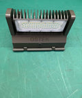 Front view of 40W Rotatable LED Wall Pack Light With 5000K Daylight Output, 5500 Lumens Outdoor Area Fixture on green background.