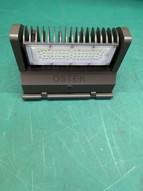 Front view of 40W Rotatable LED Wall Pack Light With 5000K Daylight Output, 5500 Lumens Outdoor Area Fixture on green background.