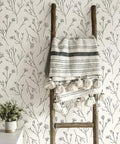 Green And White Twigs Peel And Stick Wallpaper Roll, 20.5 Inch Wide By 16.5 Feet Long, on wall with ladder and blanket