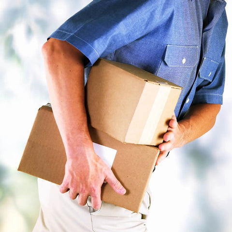 Person holding two cardboard boxes sealed with Level Up Your Shipping Heavy Duty Kraft Packing Tape 3 Inches Wide By 450 Feet Long Reinforced Water Activated Gummed Roll For Cartons That Really Grips Tight Every Time.