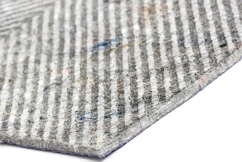 Close-up of 5x7 Foot Non Slip Rug Pad For Hard Floors With Textured Felt Surface And Natural Rubber Backing, showing striped texture.