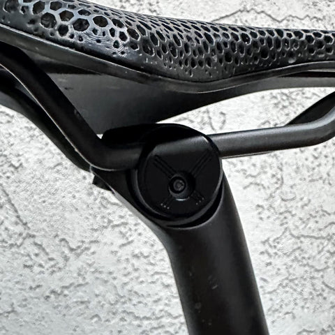 Close-up of 7x10 Seatpost Ear Clamp Titanium Bolt Kit For Oval Carbon Rails on a bicycle seatpost, showing clamp and rail details.