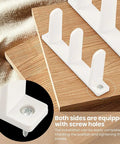 Close-up of 4 Pack Universal Closet Door Floor Guide Kit for One Three Eighths Inch Thick Doors ABS Sliding Door Bottom Guide White Durable Plastic Rail System with Eight Screws for Easy Installation showing the screw holes and placement on wooden boards.