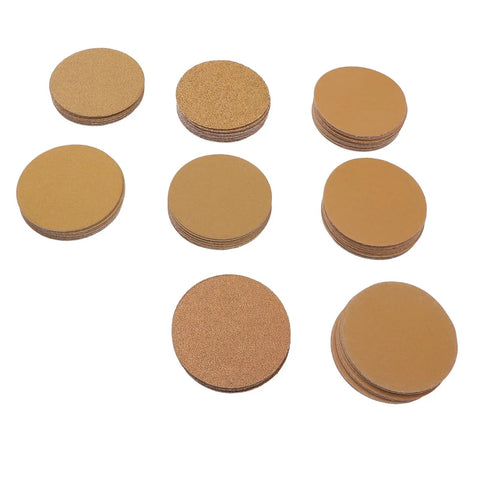 Top Tier 3 Inch Gold Aluminum Oxide Hook And Loop Sanding Discs With Hook Back For Orbital Sanders stacked in various textures.