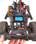 Front view of an off-road RC car chassis featuring a blue Feetech 180° servo motor and coil shocks.