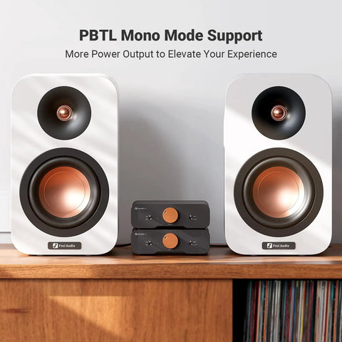 ZA3 Dual Mode Mini Stereo Amplifier For Home Audio With Mono And Stereo Power Up To 235W Mono And 180W Stereo 48V Power Supply, shown with speakers on a shelf.