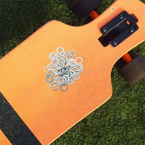 Skateboard Washers and Precision Spacers Kit Aluminum Alloy 200 Pieces on orange longboard deck