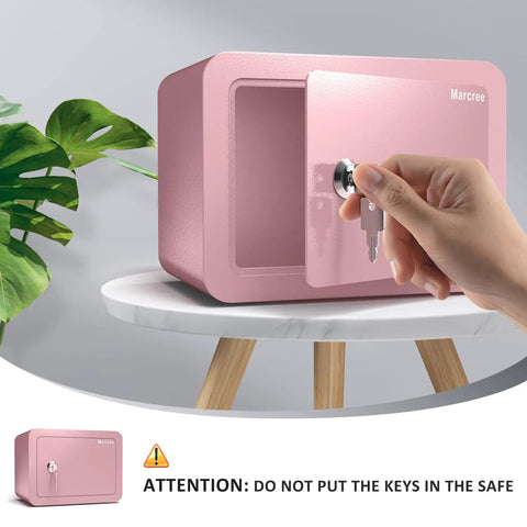 Hand opening Pink Home Safe Box For Kids And Money, Compact Lock Box With Key, 6.69 x 9.06 x 6.69 inches, on table