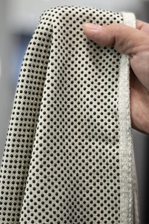 Close-up of Quick Drop 8 Oz Canvas Safety Drop Cloth with slip resistant dots, showing heavy duty fabric texture for projects.