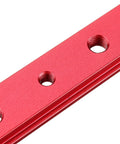Close-up of red anodized aluminum miter bar slider for T slot table saw track, featuring threaded holes.