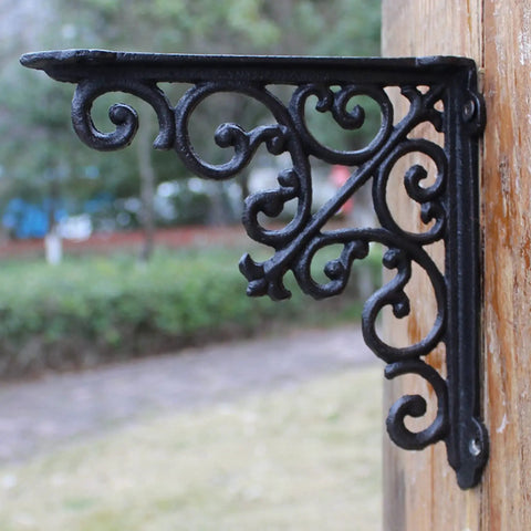 Built Tough Heavy Duty Cast Iron Wall Shelf Brackets Rust Proof 90 Degree Corner Braces with ornate design mounted on wood.